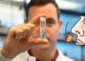 Osmo's CEO holds a vial used for olfactory teleportation, flanked by an illustration representing the smell of plums.